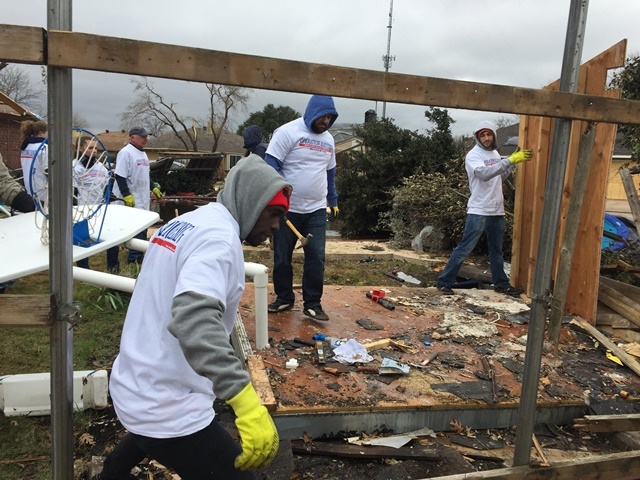 TIers help clean debris after tornado devastation.