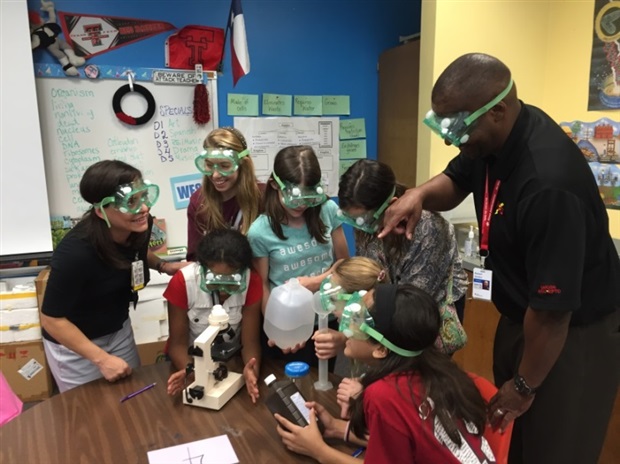 Robert encourages safety during a science project with students at Hamilton Park Elementary School. 